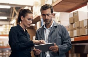 Shot of a young man and woman using a digital tablet while working together in a warehouse